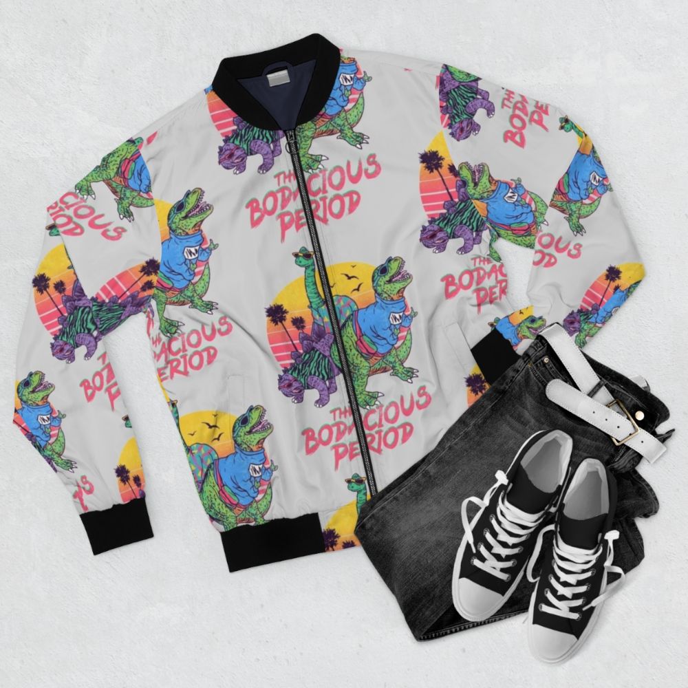 A dinosaur-themed 80s retro bomber jacket with a bold, colorful design. - Flat lay