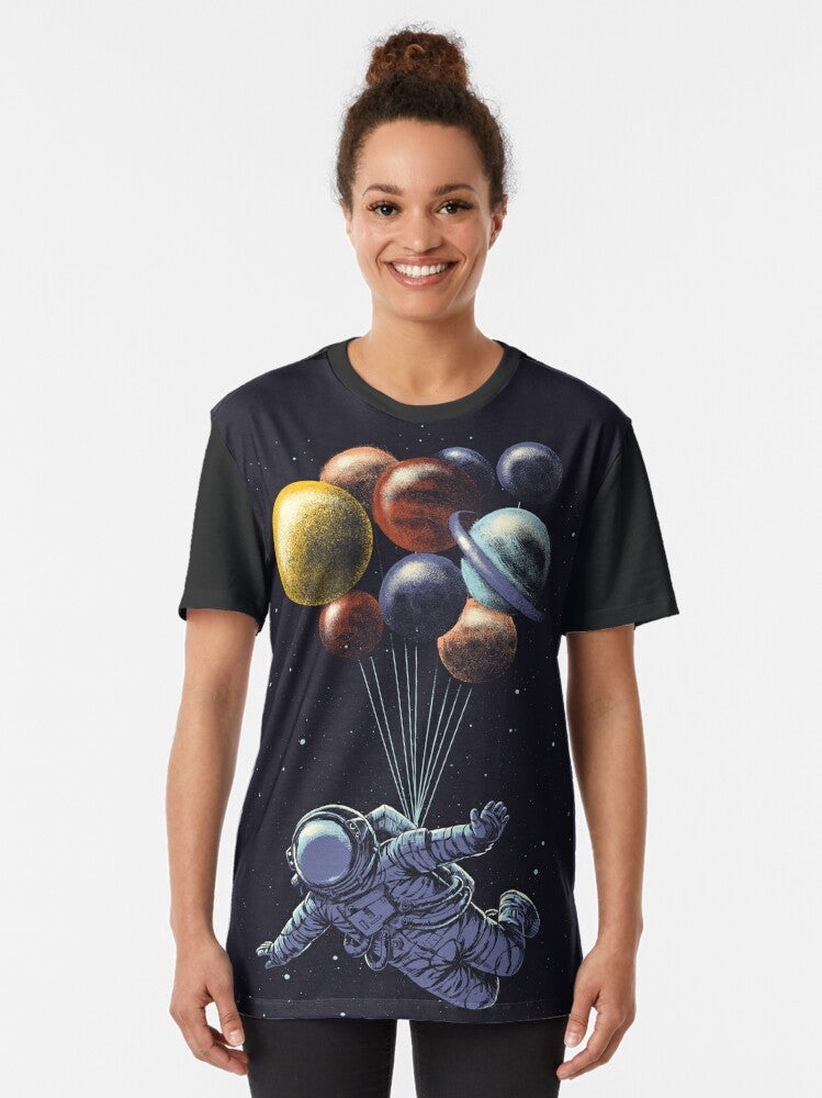 Space travel graphic t-shirt featuring a colorful, surrealist design of the solar system and cosmic elements - Women