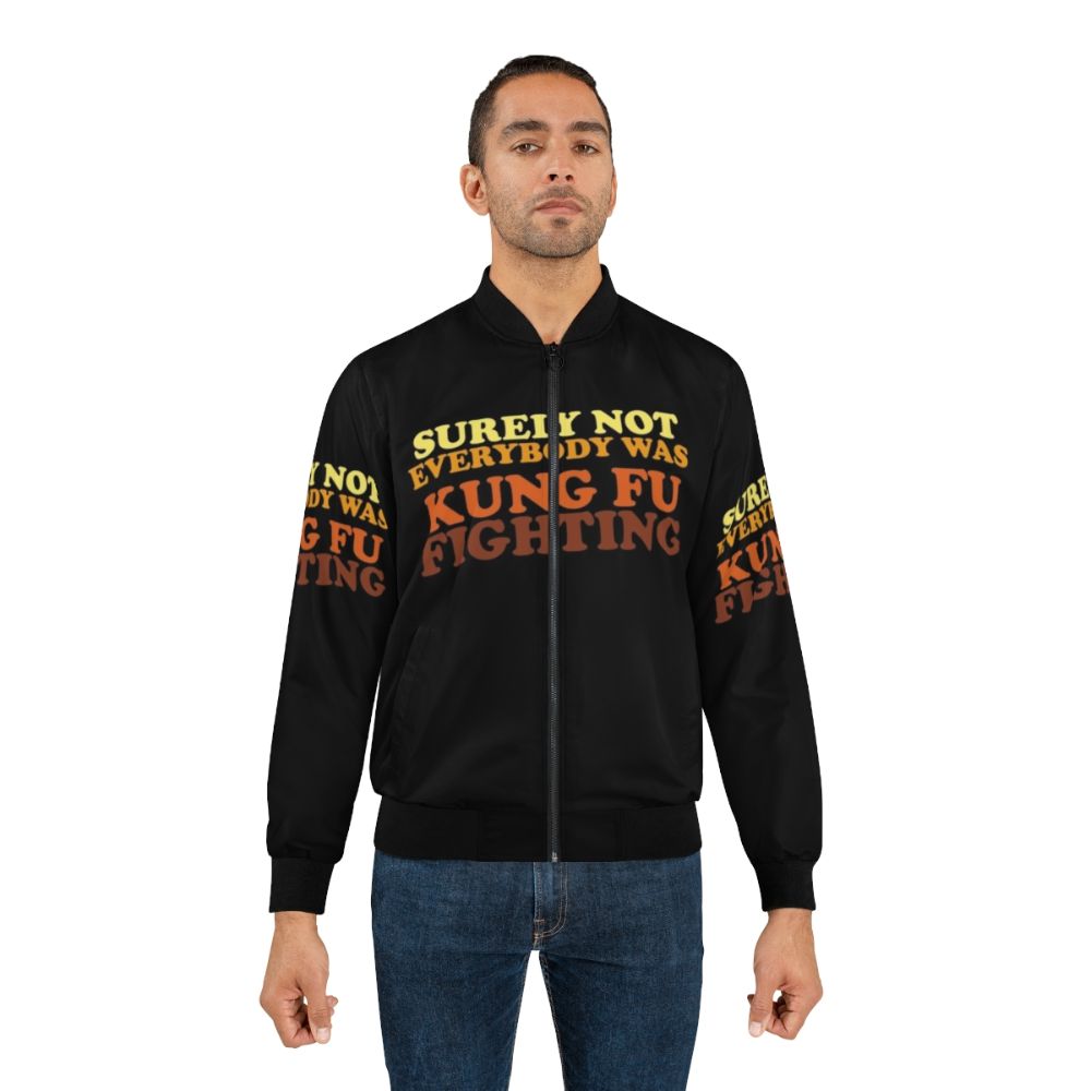 A retro-style bomber jacket with the iconic "Surely Not Everybody Was Kung Fu Fighting" design, featuring martial arts and 70s music references. - Lifestyle