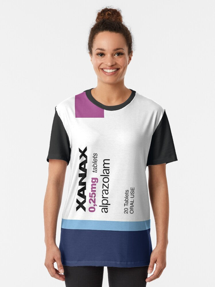 A graphic t-shirt featuring the word "XANAX" in a bold, stylized font, surrounded by various meme-inspired elements like rainbows, pods, and avocados. - Women