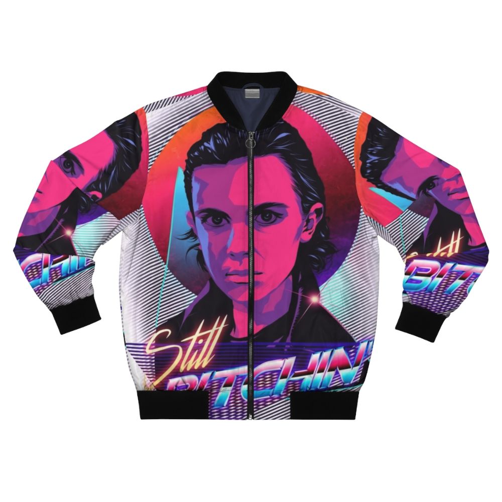 Eleven from Stranger Things wearing a bomber jacket with the text "Eleven is Still Bitchin"