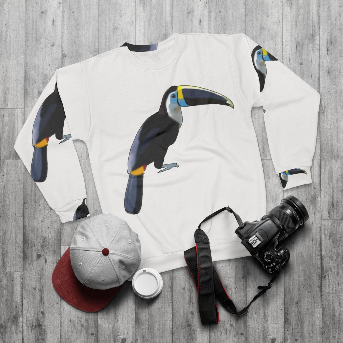 Blue toucan graphic on a cozy sweatshirt - flat lay