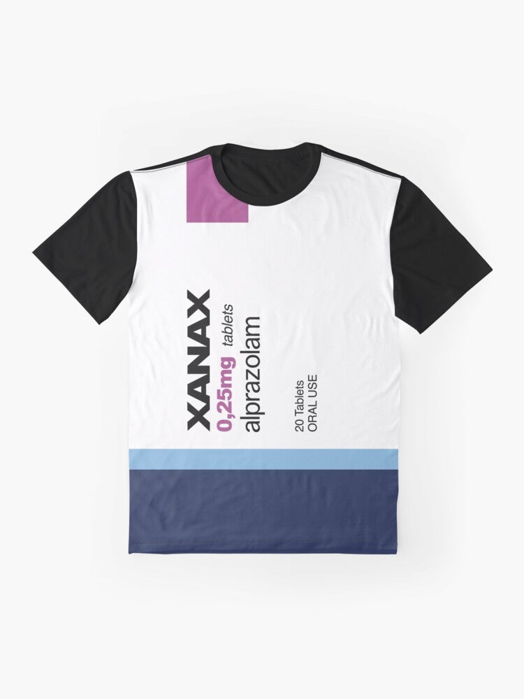 A graphic t-shirt featuring the word "XANAX" in a bold, stylized font, surrounded by various meme-inspired elements like rainbows, pods, and avocados. - Flat lay