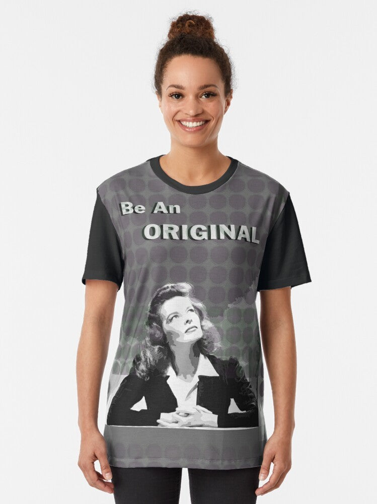 Graphic t-shirt with a portrait illustration of Katharine Hepburn, a famous movie star known for her iconic fashion style and trouser suits. - Women