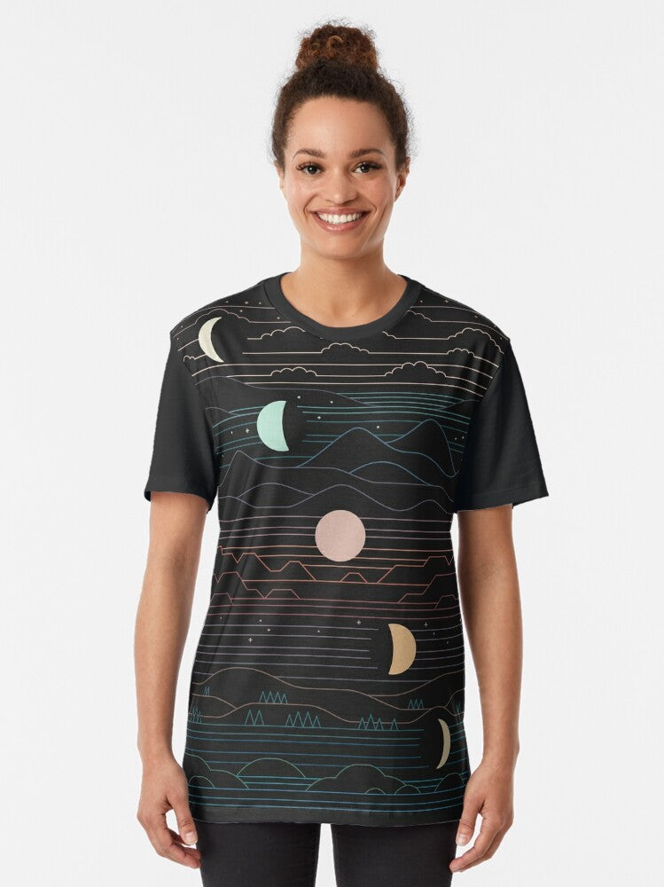 Graphic t-shirt featuring a design of a crescent moon and mountain landscape against a starry night sky - Women