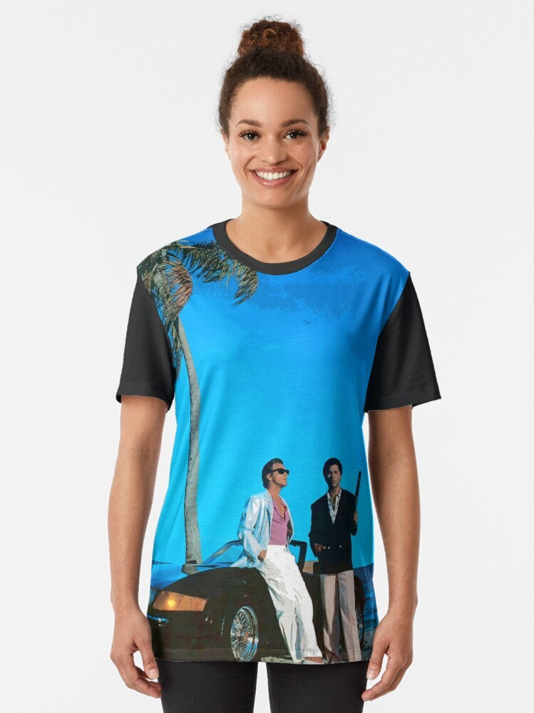 Retro Miami Vice inspired t-shirt featuring a blue graphic design with the words "Miami Vice" and characters Crockett and Tubbs from the 1980s TV series. - Women