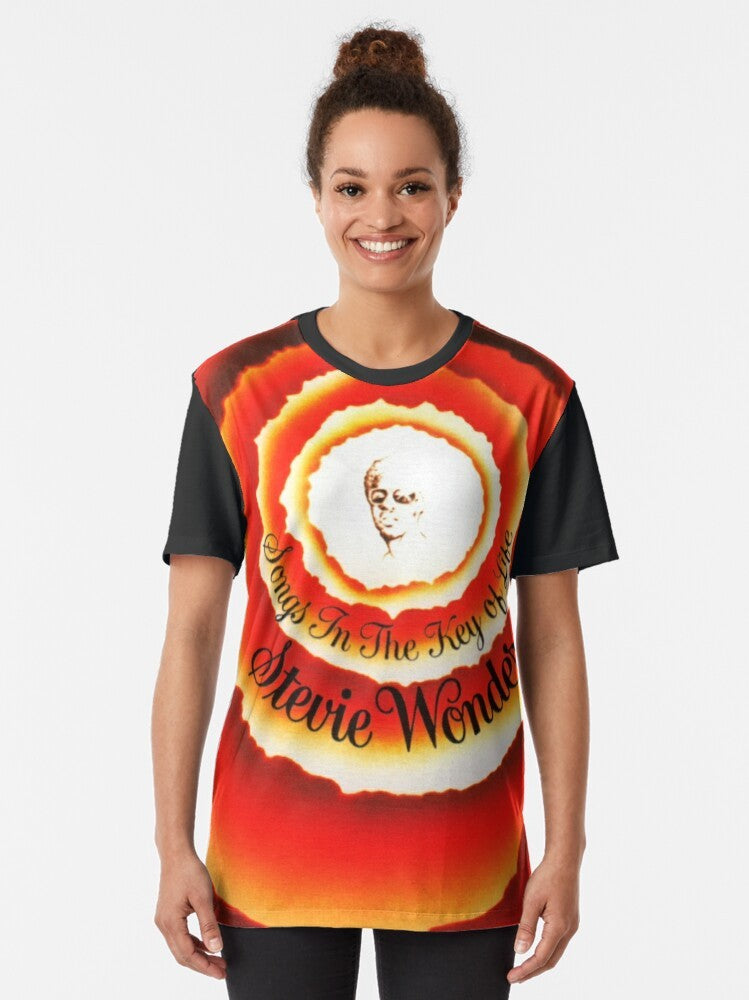 "Songs in the Key of Life" Stevie Wonder graphic t-shirt featuring a vibrant, colorful design celebrating the iconic album. - Women