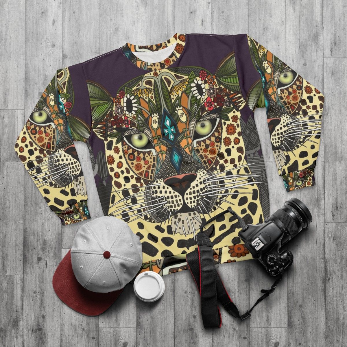 Leopard print sweatshirt with tribal and botanical design - flat lay