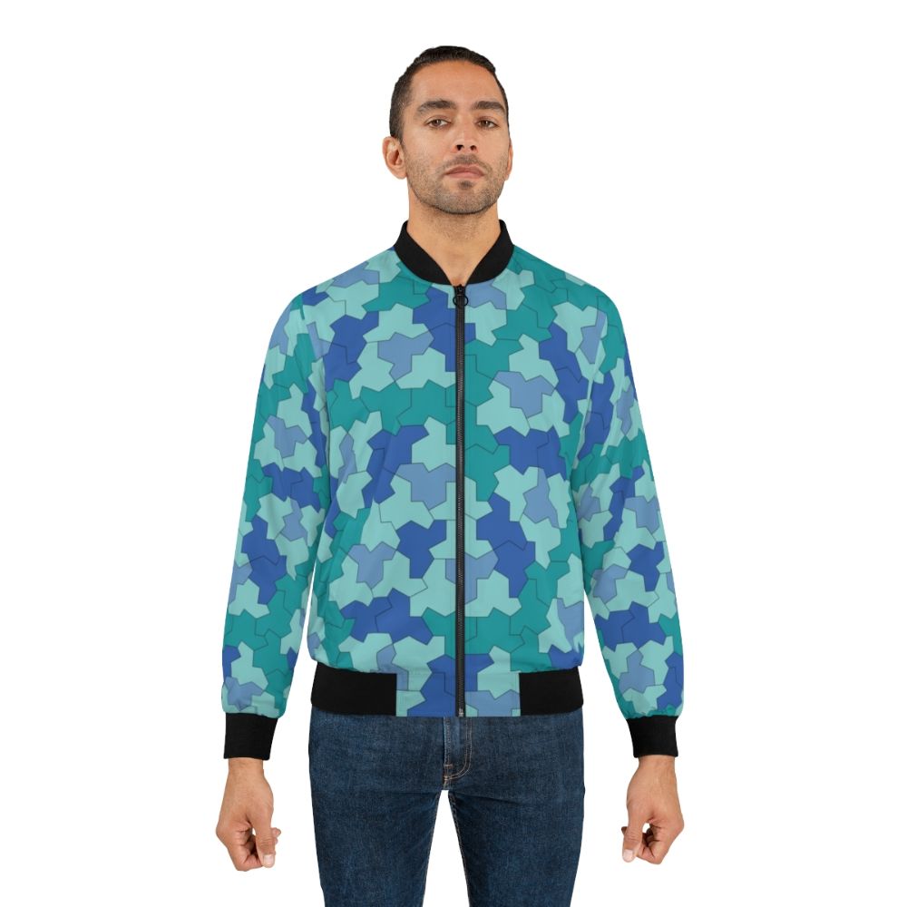 A blue and green bomber jacket featuring geometric Einstein shapes and aperiodic monotile patterns. - Lifestyle