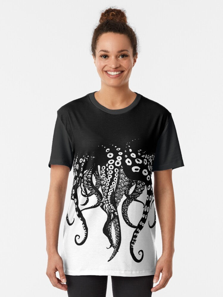 A black and white graphic t-shirt featuring a mysterious tentacled creature symbolizing the passionate and intimate embrace of love. - Women