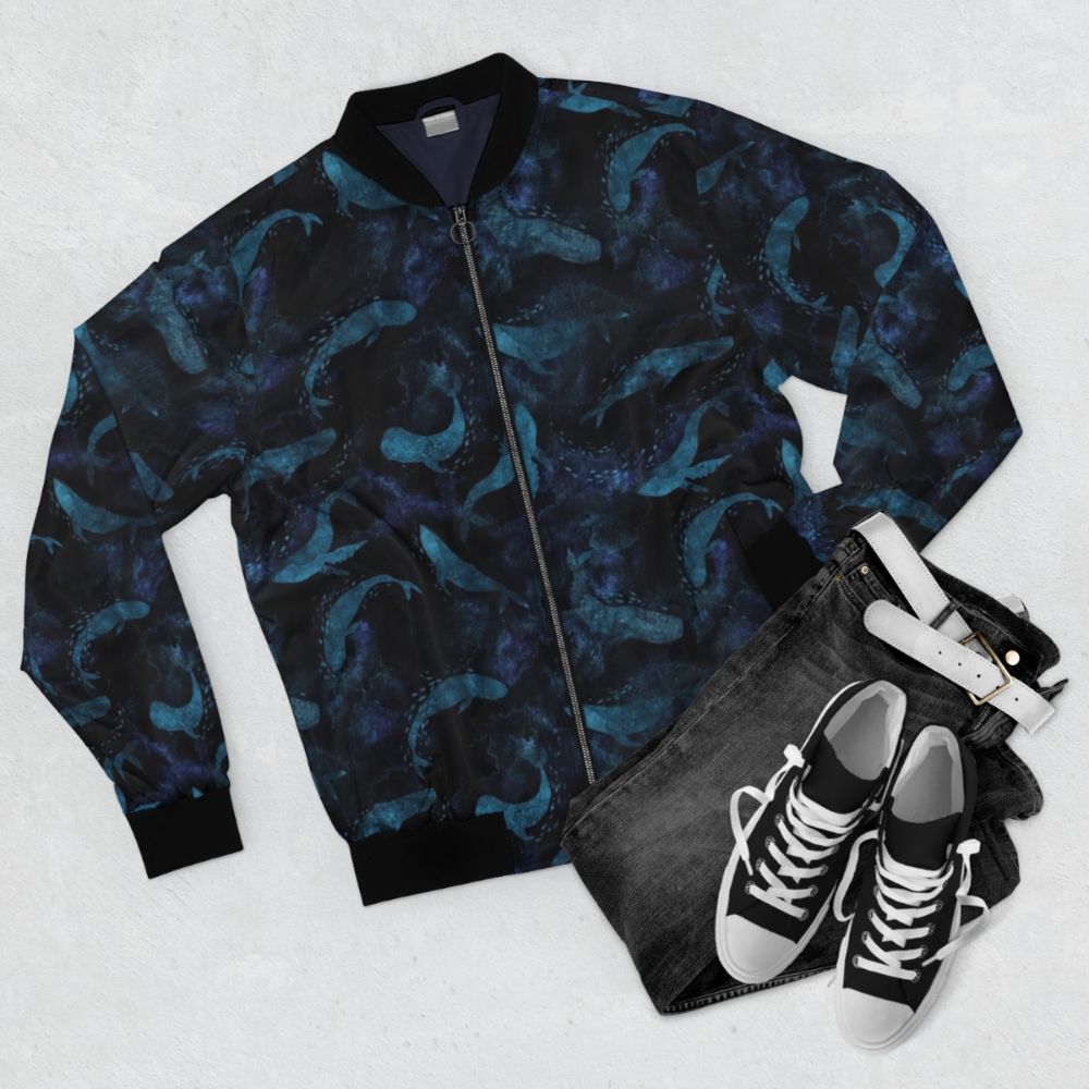 Indigo blue bomber jacket with a whale design, showcasing the graceful movements of whales in the deep blue ocean. - Flat lay