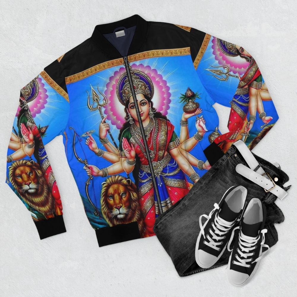 Vintage bomber jacket featuring a Hindu god design with arrows, mountains, staff, and other traditional Indian elements. - Flat lay