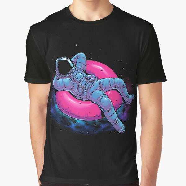 A graphic t-shirt design featuring a floating astronaut in a dreamy, cosmic space scene with stars, nebula, and other celestial elements.