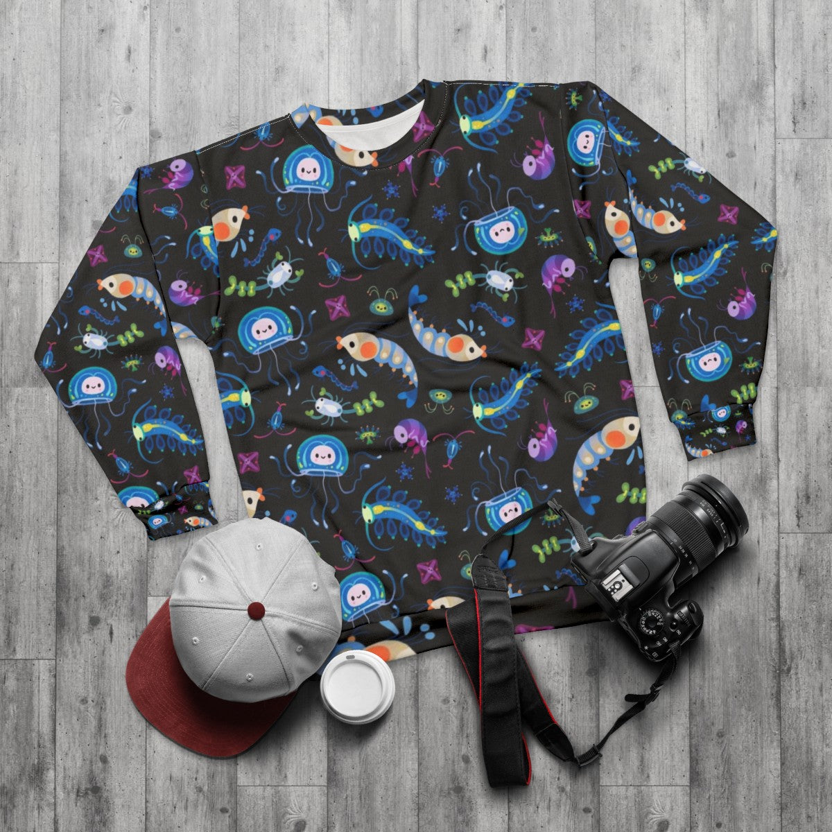 Zooplankton sweatshirt featuring microscopic ocean creatures - flat lay