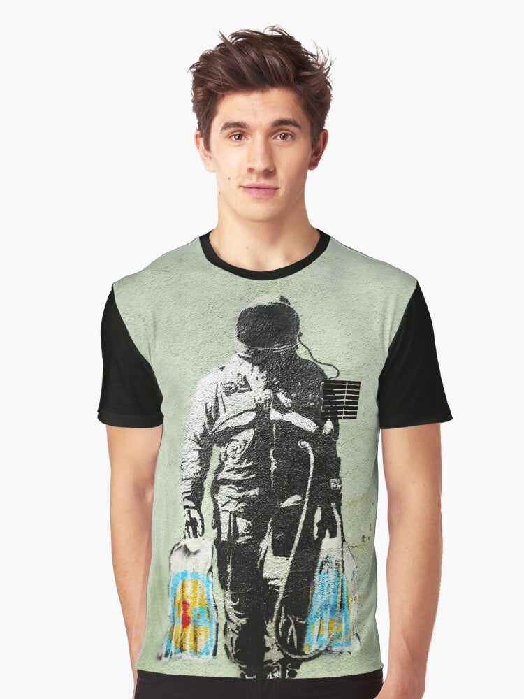 Banksy-inspired graphic t-shirt featuring an astronaut carrying shopping bags, a commentary on consumerism and society. - Men