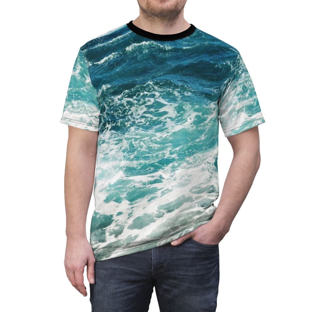 Model wearing a blue t-shirt with an abstract ocean waves pattern - men front