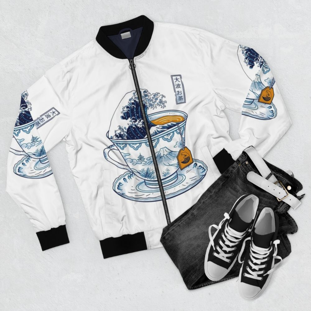 A bomber jacket featuring the iconic "The Great Wave off Kanagawa" design and a tea theme. - Flat lay