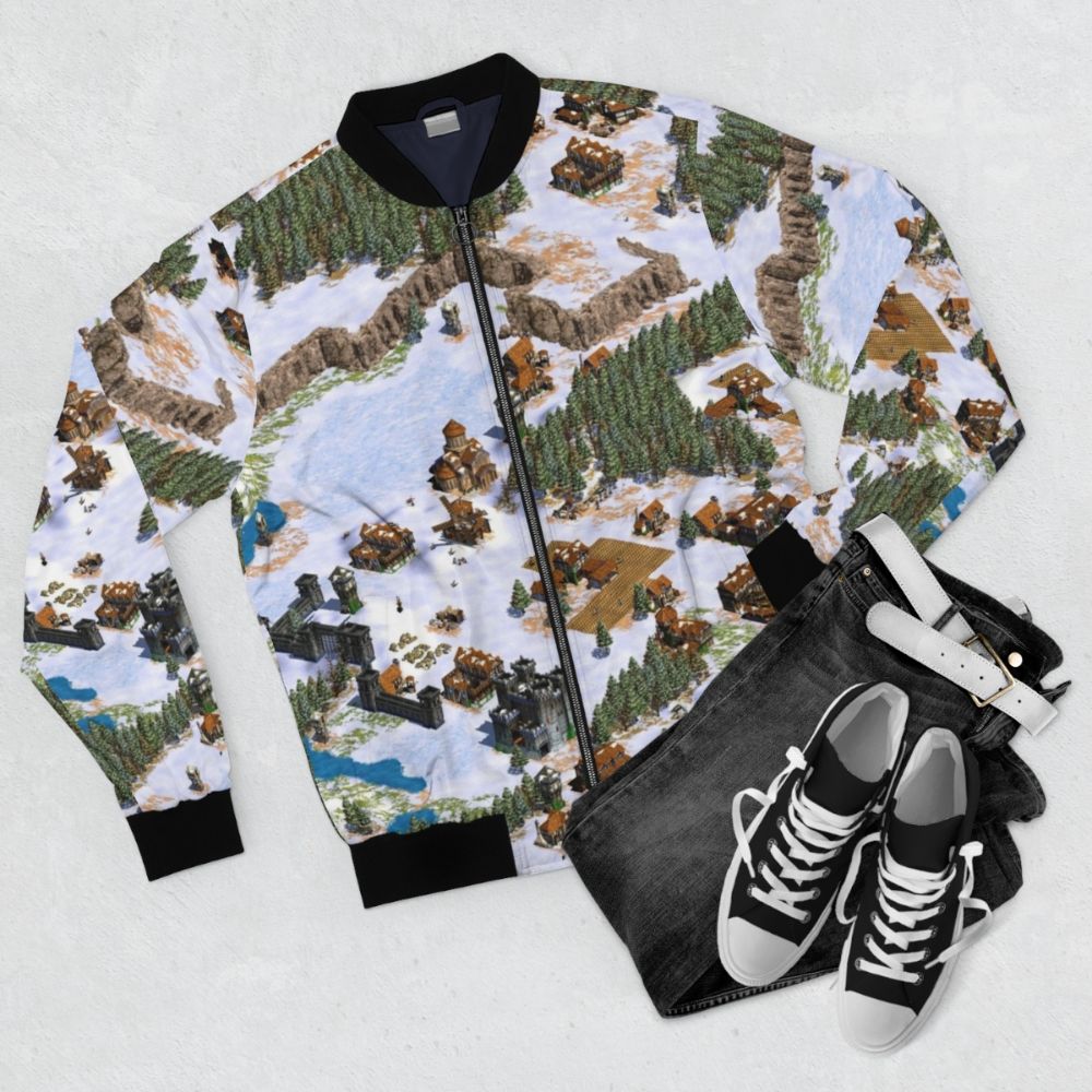 Vintage-style bomber jacket featuring the Age of Empires game logo and snowy landscape design - Flat lay