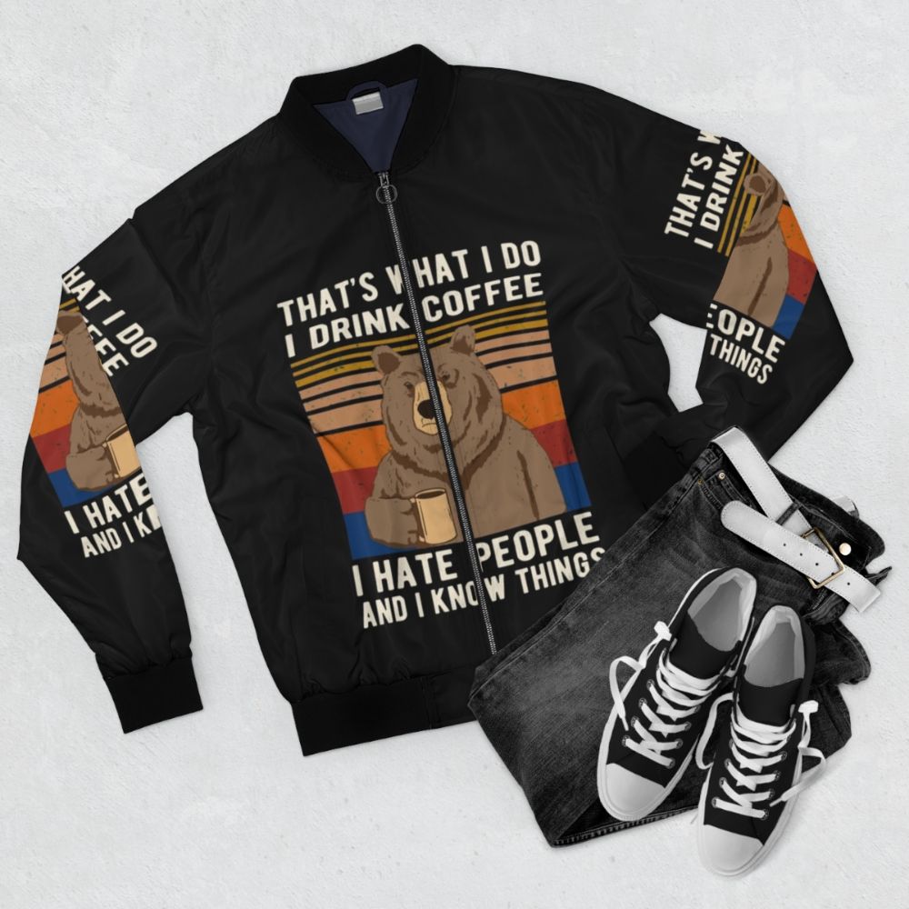 Funny bear drinking coffee bomber jacket with text "That's What I Do I Drink Coffee I Hate People And I Know Things" - Flat lay