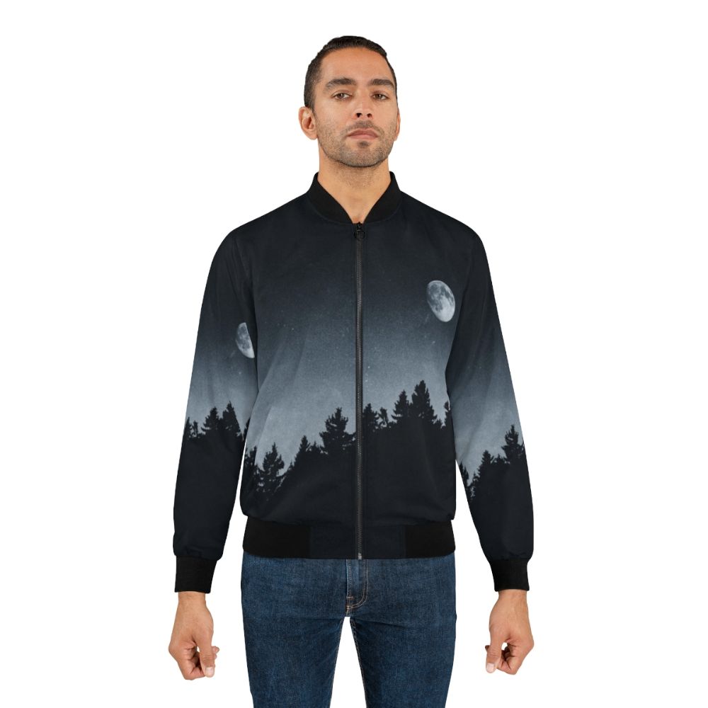 A black bomber jacket with a nature-inspired design, featuring the moon, trees, and a mysterious landscape. - Lifestyle