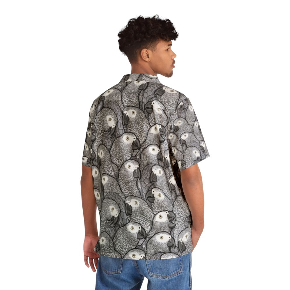 Colorful Hawaiian-style shirt featuring African grey parrots - Flat lay