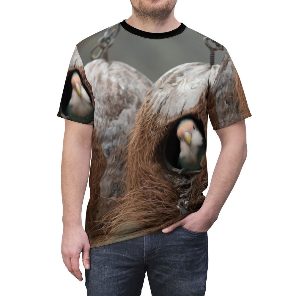 T-shirt featuring a vibrant design of birds, nests, and feathers in a natural landscape. - men front