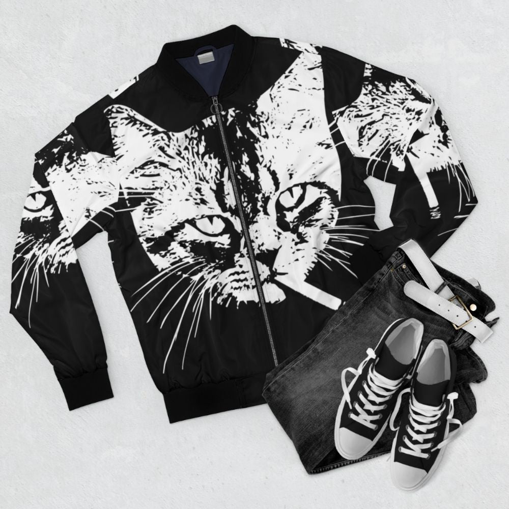 Tabby cat smoking on a pastel goth bomber jacket - Flat lay