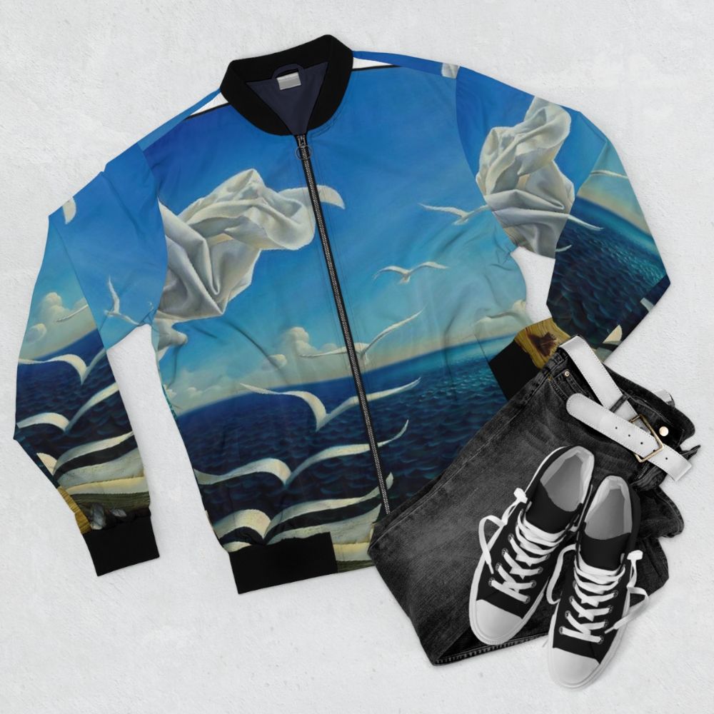 Vintage fantasy surreal print bomber jacket featuring book pages, birds, and sun imagery - Flat lay