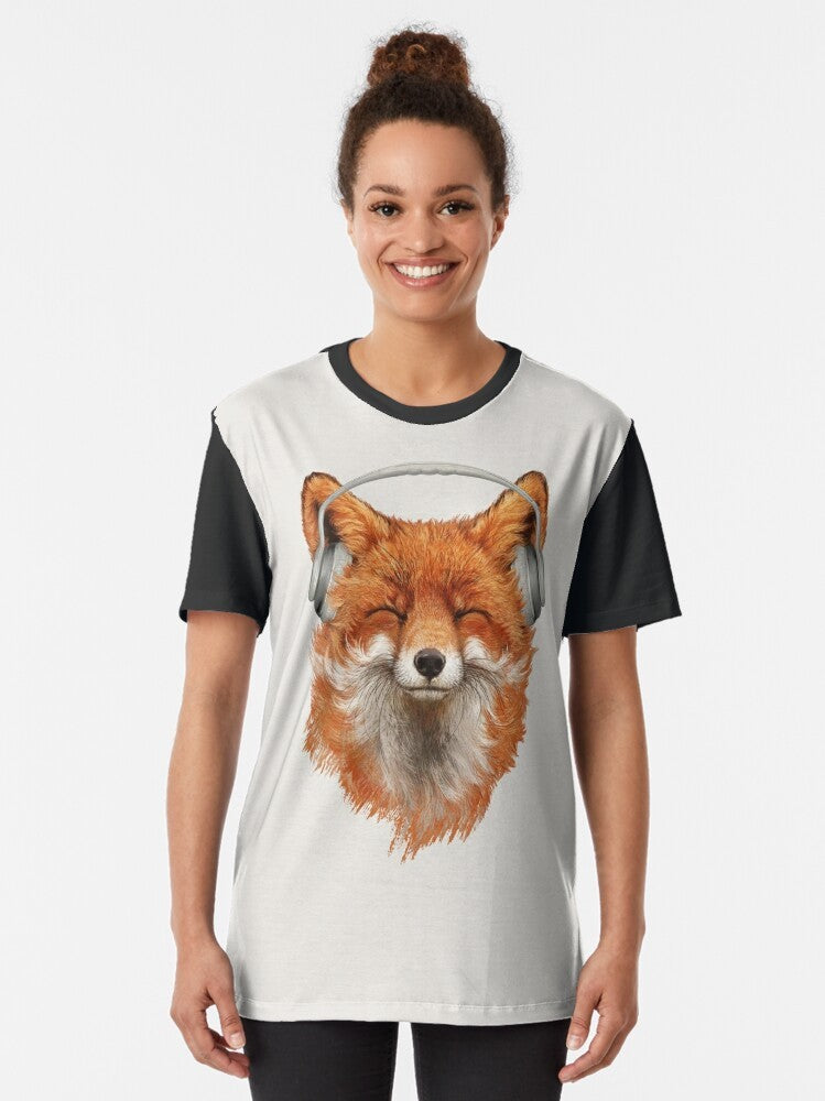 A graphic t-shirt featuring a smiling, musical fox with headphones and a mustache. - Women