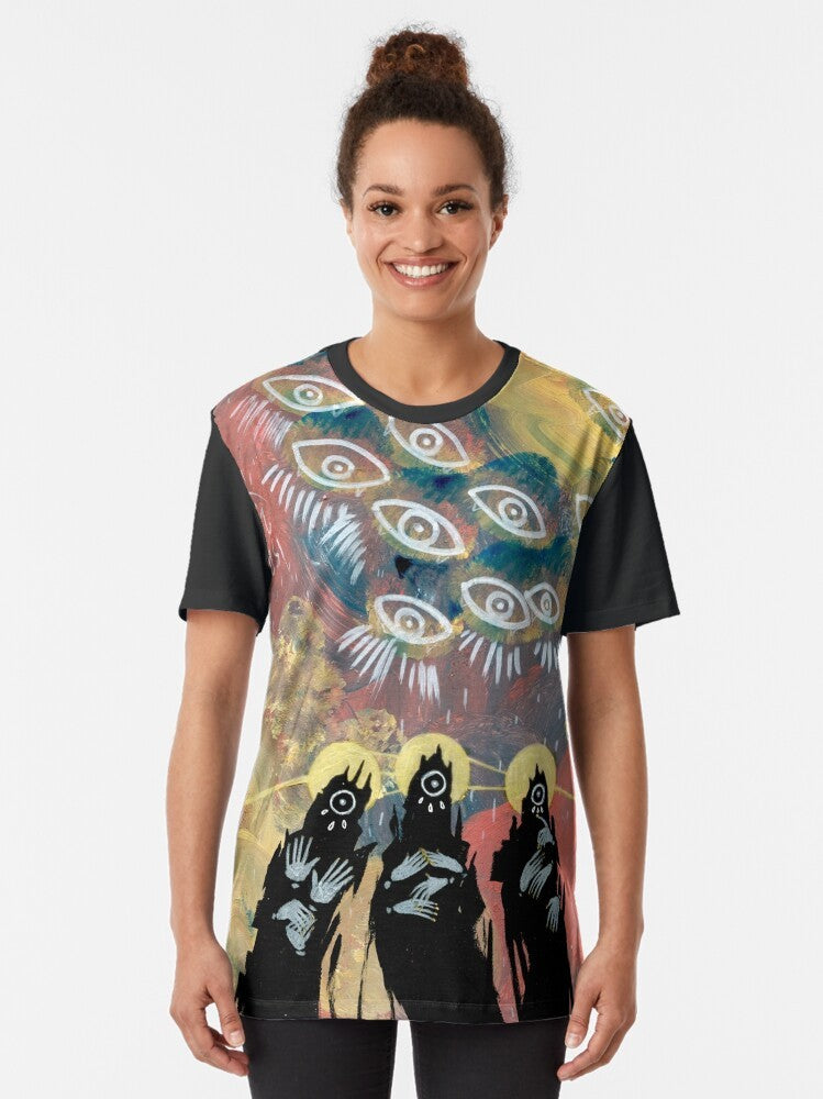 A graphic t-shirt featuring an eldritch, creepy eye design with a surreal, gothic horror aesthetic. - Women