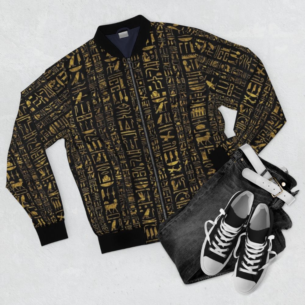 Vintage Egyptian hieroglyphs bomber jacket in black with gold accents - Flat lay