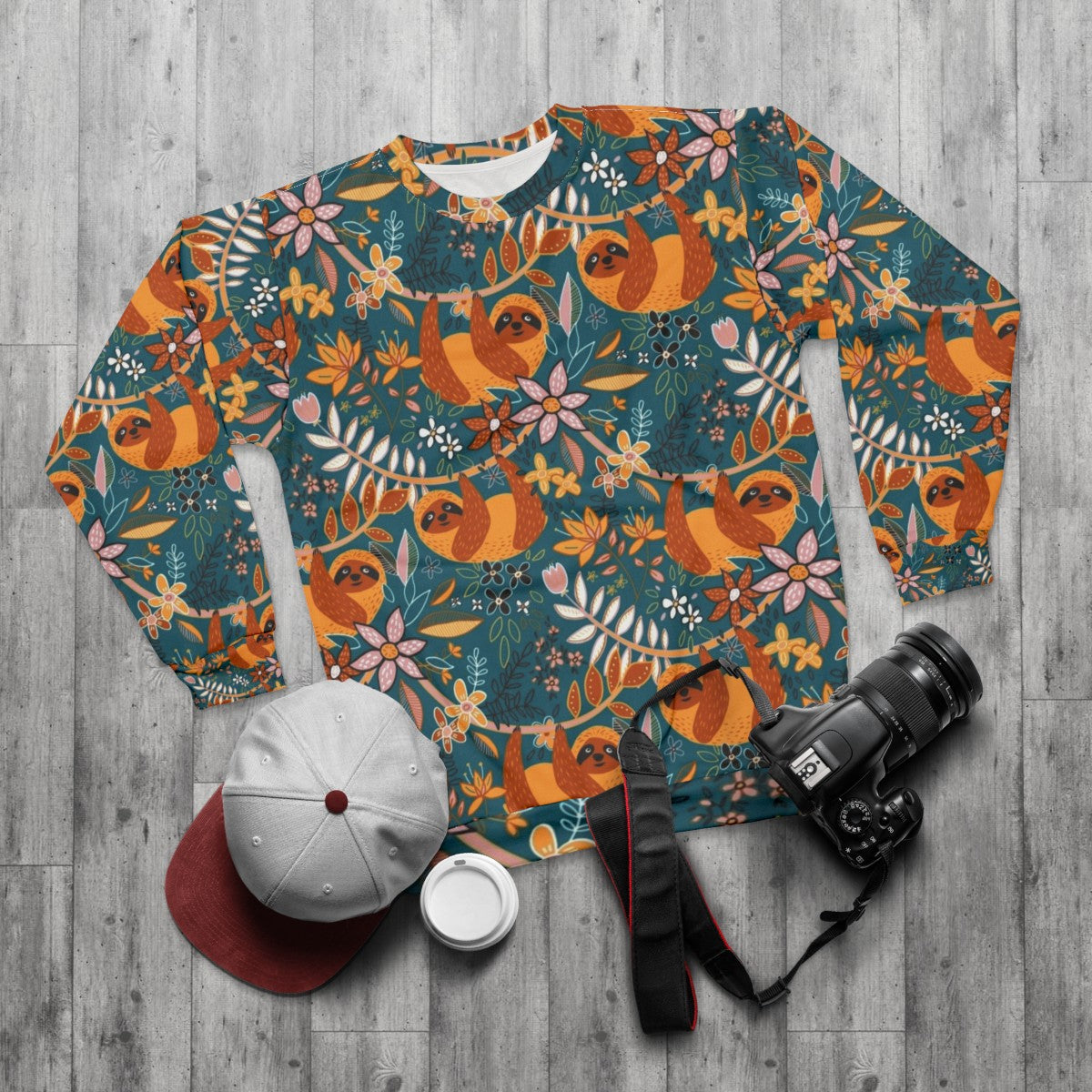 Boho floral sloth sweatshirt with teal, orange, and blush colors - flat lay