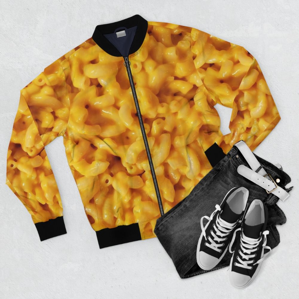 A bomber jacket featuring a graphic design of macaroni and cheese, perfect for food lovers. - Flat lay