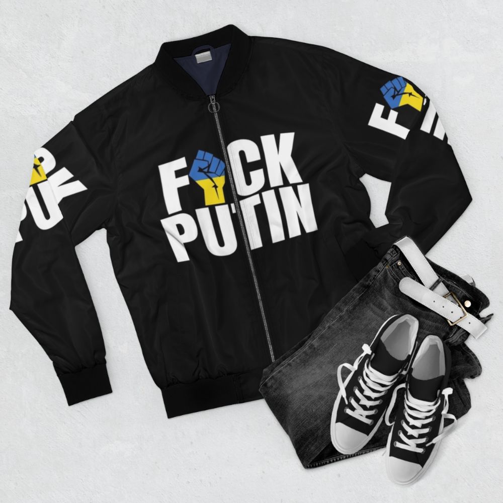 Ukrainian flag bomber jacket with fist symbol, anti-Putin design - Flat lay