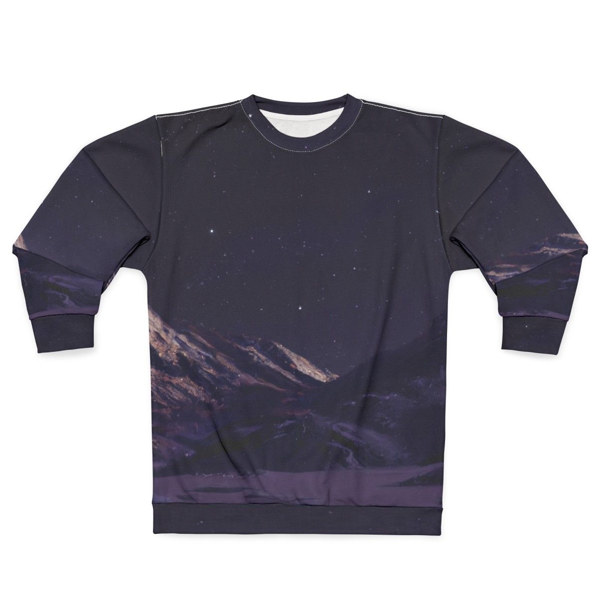 A person wearing a sweatshirt featuring a design of mountains against a night sky filled with stars.