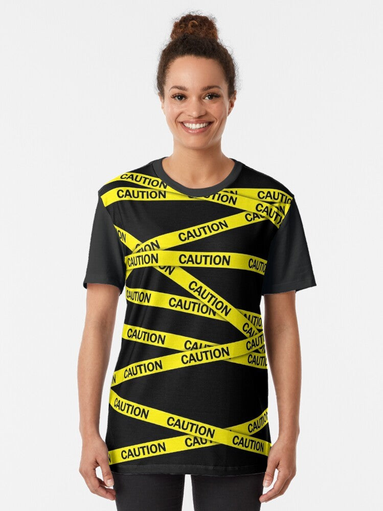 Caution tape graphic t-shirt featuring a bold, bright yellow and black warning design - Women