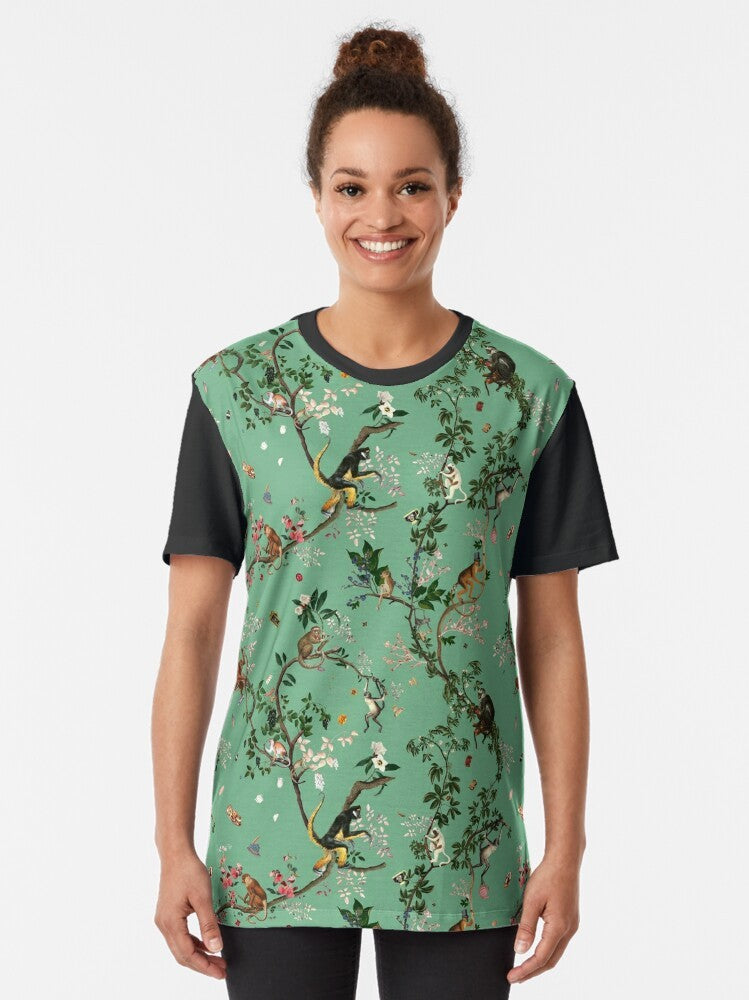 A vibrant green t-shirt featuring a playful monkey design amidst a lush, tropical floral pattern. - Women