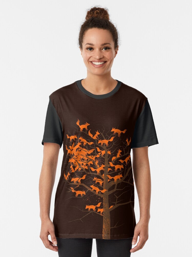 A vibrant graphic t-shirt featuring a mystical fox amidst a blazing tree, evoking the beauty of autumn nature. - Women