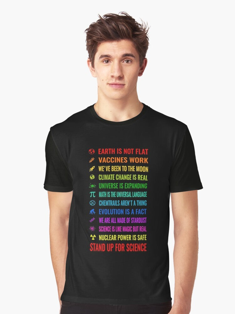 Graphic t-shirt with text "Earth is not flat! Vaccines work! We've been to the moon! Chemtrails aren't a thing! Climate change is real! Stand up for science! Universe is expanding! Nuclear power is safe!" - Men