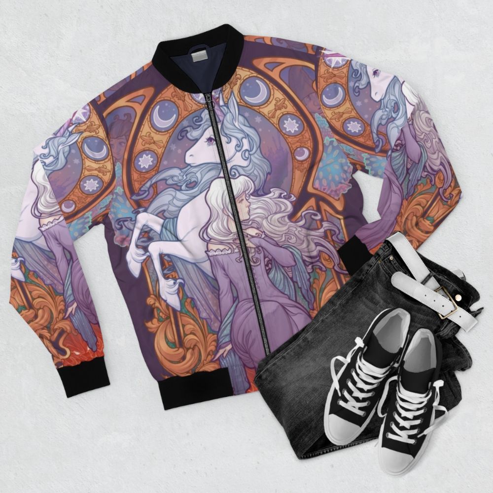 A colorful bomber jacket featuring the character Lady Amalthea from the classic 80s fantasy film "The Last Unicorn". - Flat lay