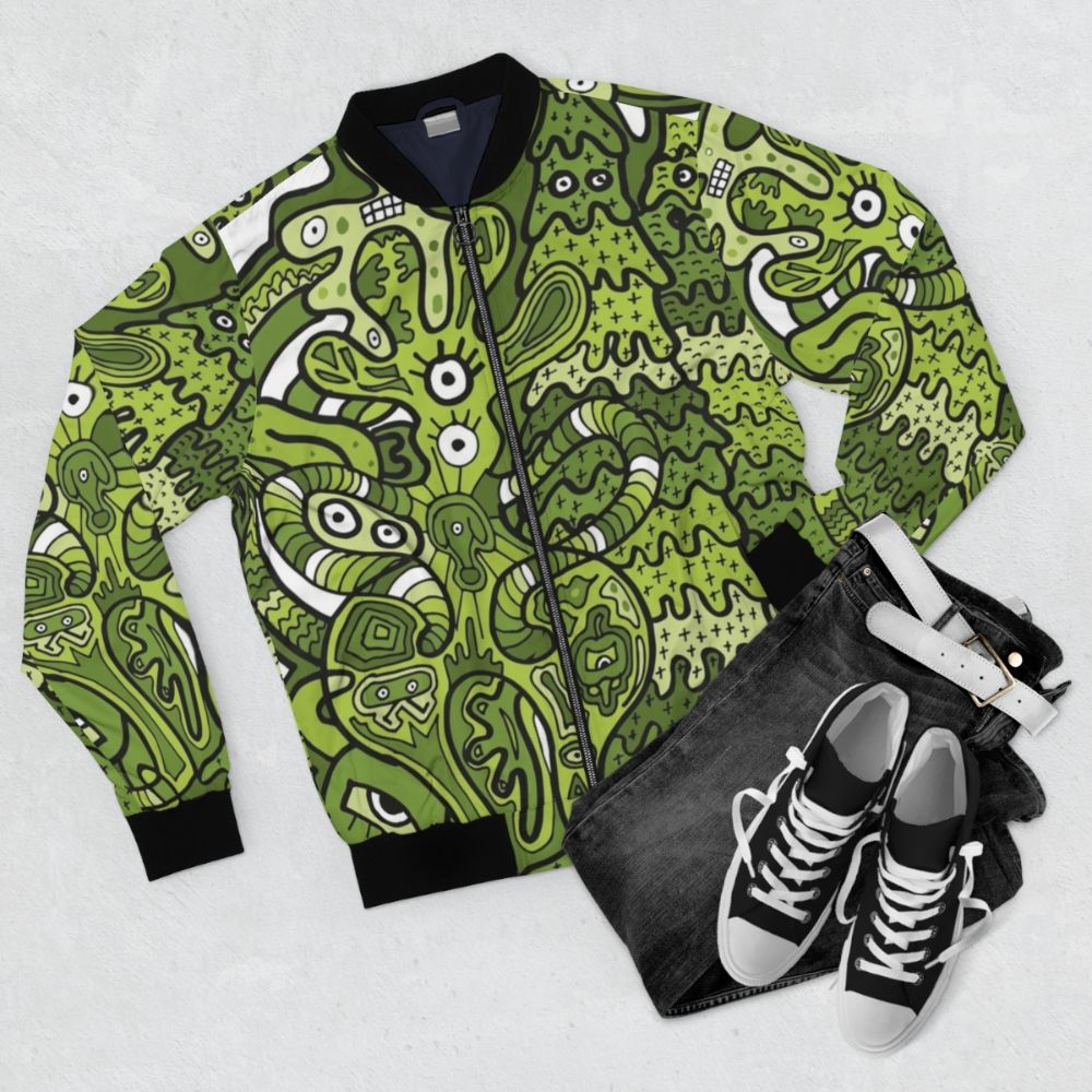 A vibrant bomber jacket featuring a doodle of a bouncing squid-like creature in various colors. - Flat lay