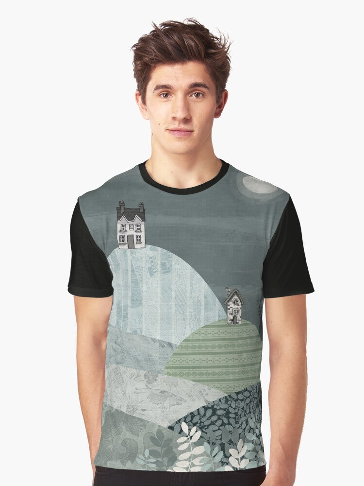 Cozy winter landscape graphic t-shirt featuring a village nestled in hills under a starry night sky - Men