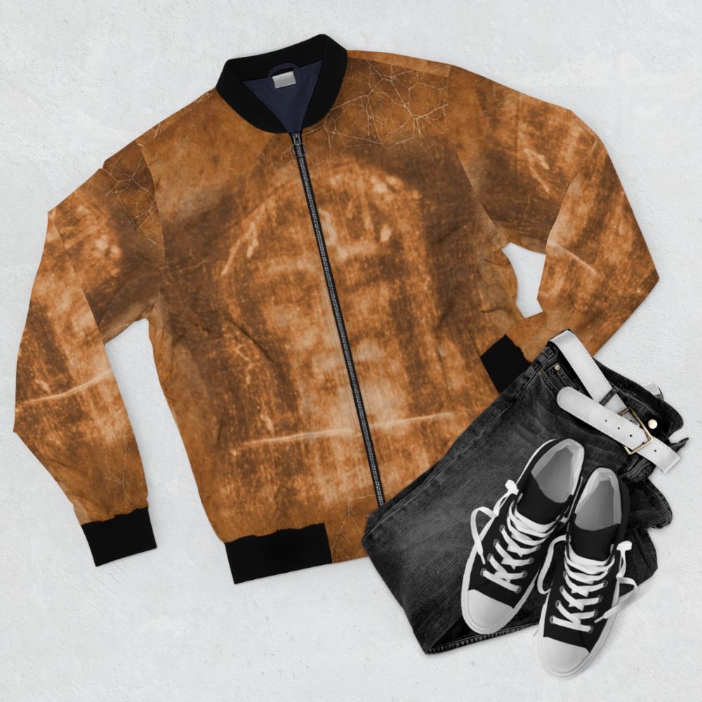 Passion of Christ Crucifix Bomber Jacket featuring the Holy Face of Jesus - Flat lay